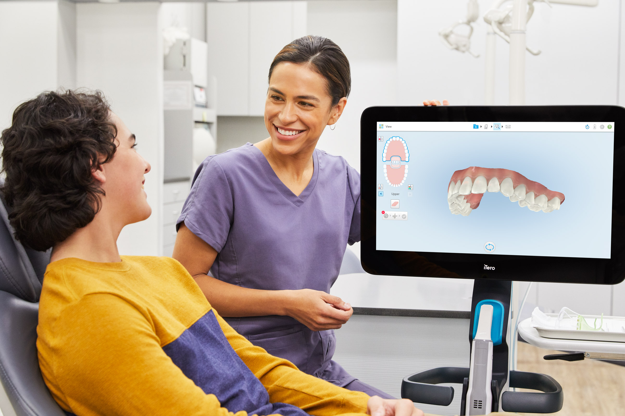 Macquarie Dentist - A dentist explaining the dental result in the screen with her patient.