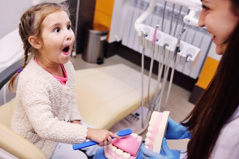 Macquarie Dentists - A child feeling amaze to dental things