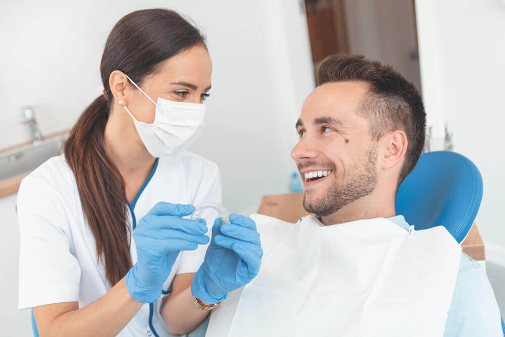 Macquarie Dentists - female dentist explaining to patient