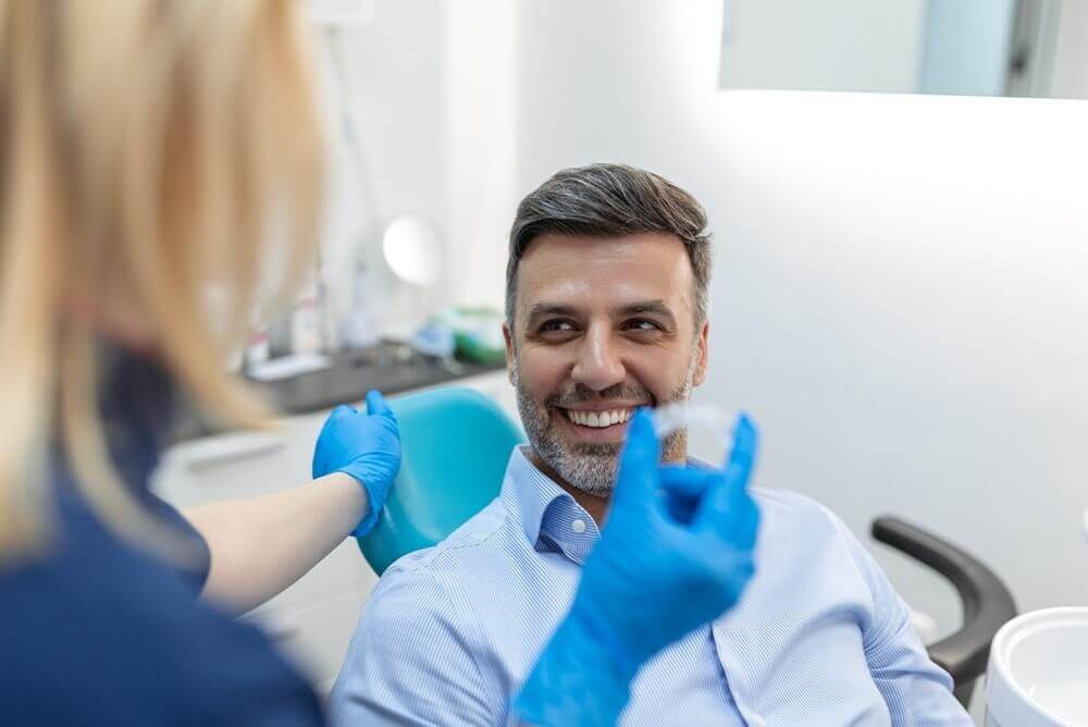 Macquarie Dentists - a dentist showing Invisalign to patient
